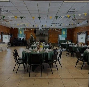 Banquet room decorated in green and gold for a holiday event
