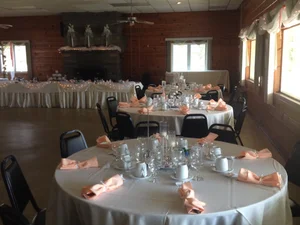 Banquet room set for an event with stone fireplace at Genegantslet Golf Club