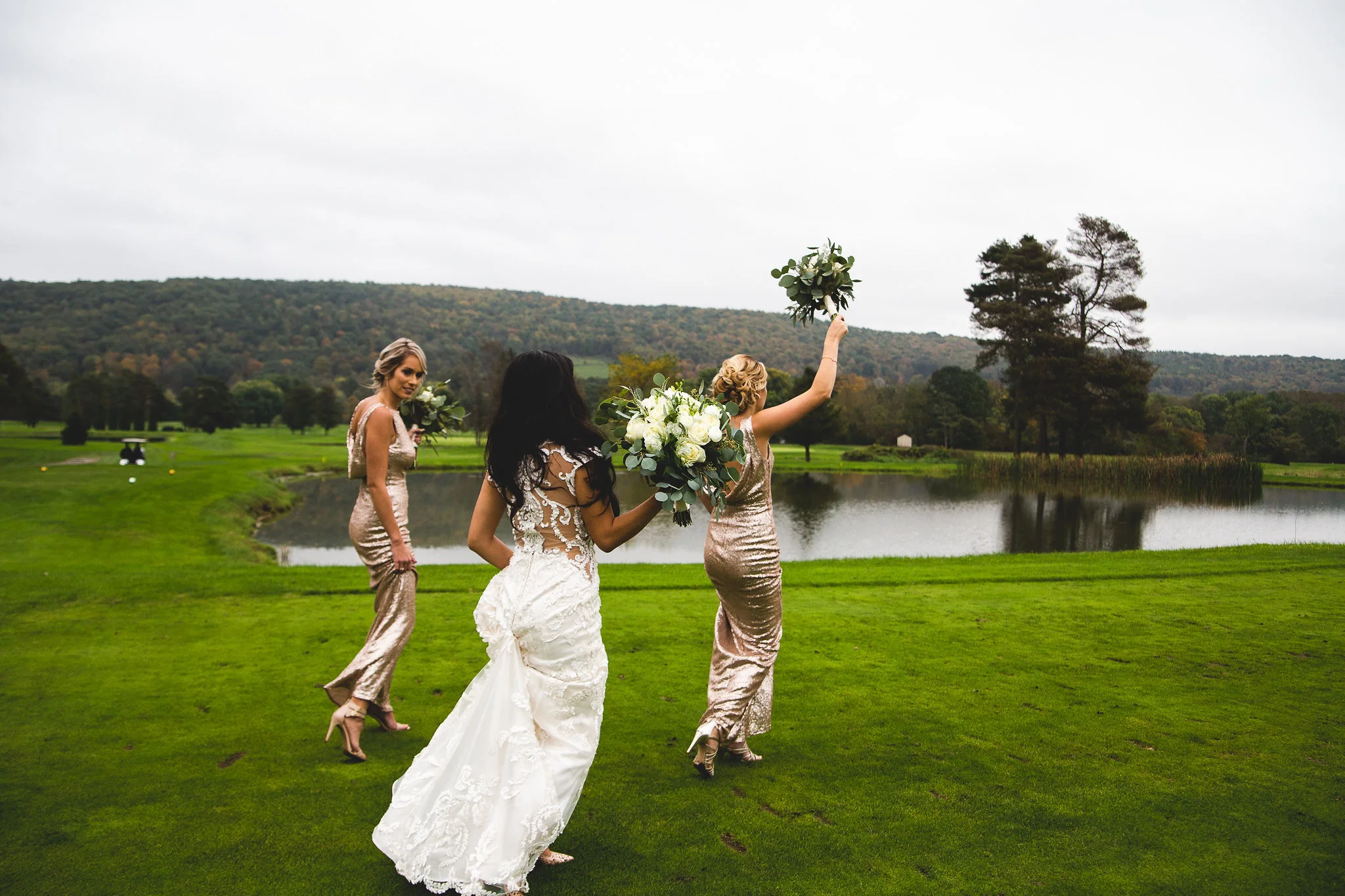 Bridal party walking together on the golf course
