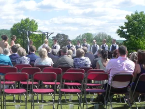 Wedding guests seated outdoors for the ceremony