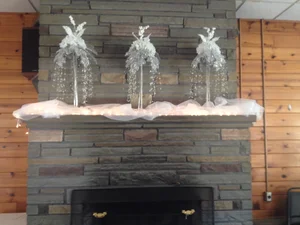 Stone fireplace with elegant silver winter decor