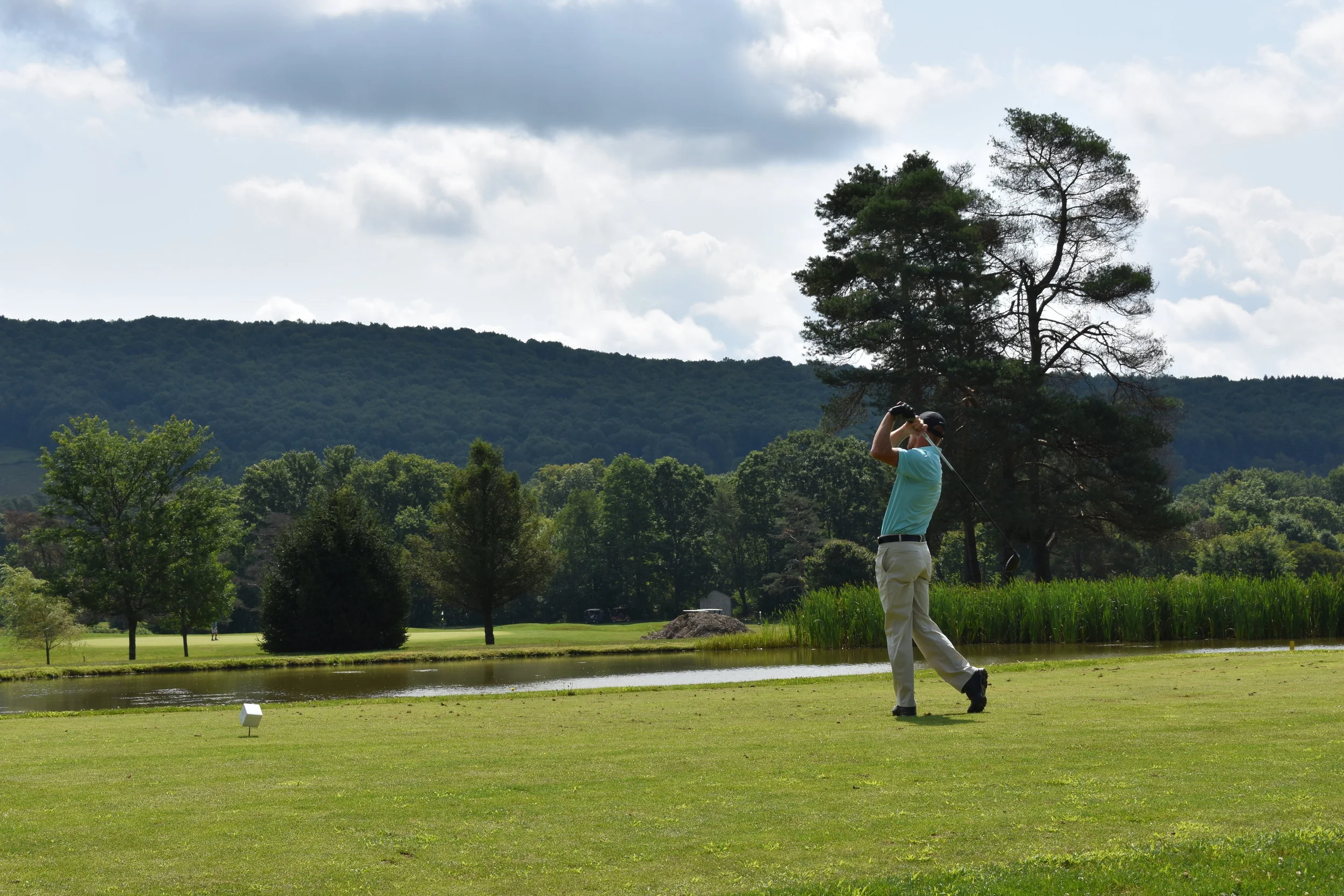 Panoramic view of Genegantslet Golf Club's 18-hole championship course nestled in the Chenango River valley with mountain views