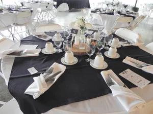 Rustic wood centerpiece with navy accents in the pavilion
