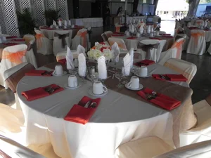 Elegant pavilion setup with red chair sashes