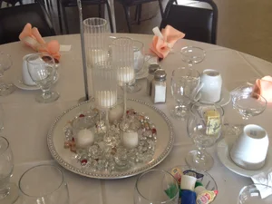 Crystal candle holders with peach accents on a table setting